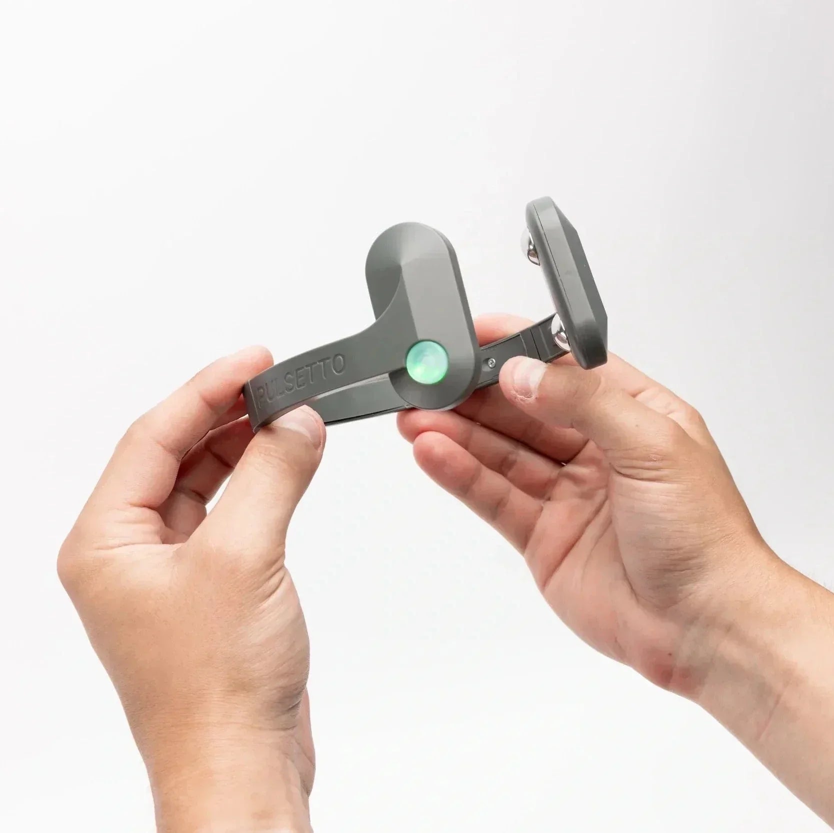 Pulsetto vagus nerve stimulation device held in hands, showcasing compact design for at-home vagus nerve therapy and natural anxiety relief.