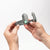 Pulsetto vagus nerve stimulation device held in hands, showcasing compact design for at-home vagus nerve therapy and natural anxiety relief.